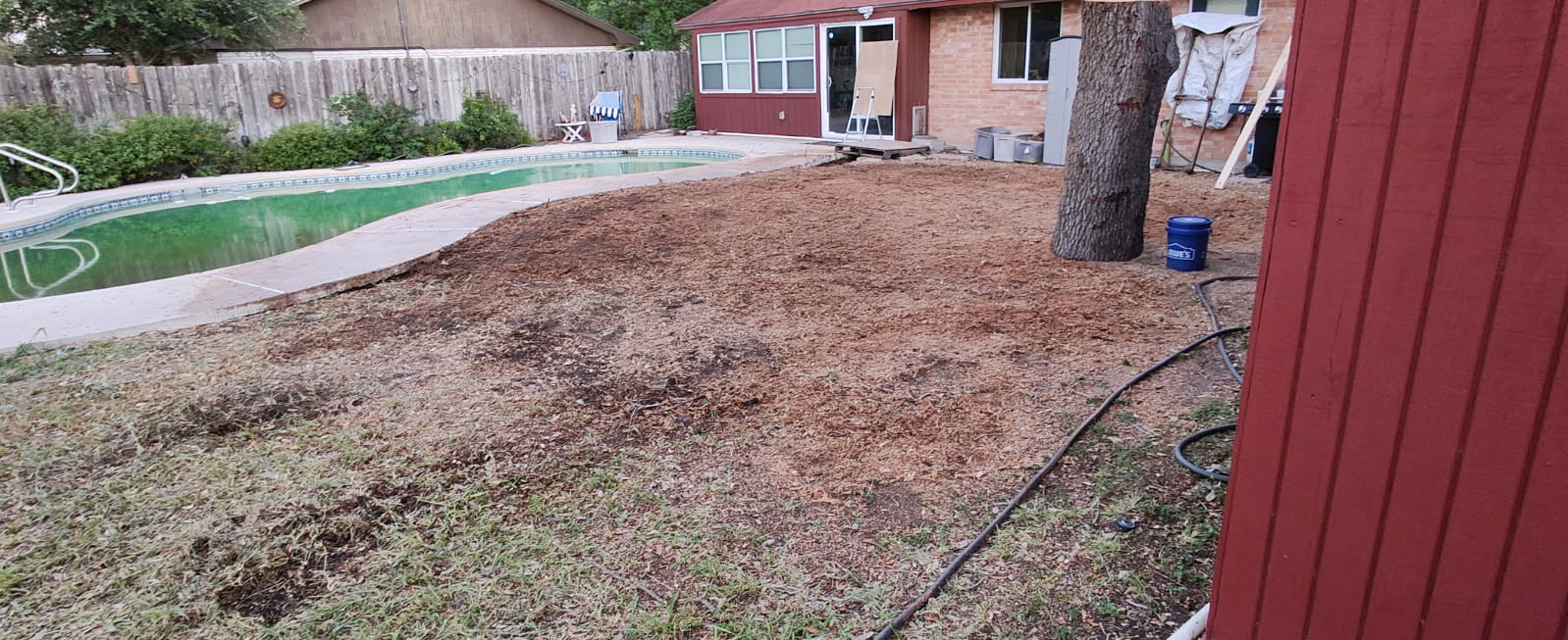 Finished stump grinding project showing clean mulched area ready for landscaping